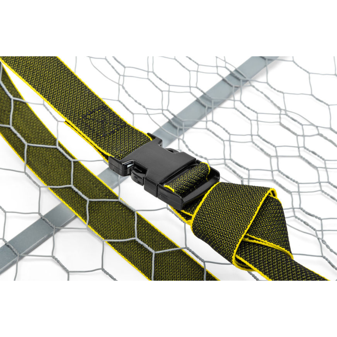 A close-up of a black plastic quick-release buckle strap with olive green and yellow webbing, shown against a white background with a gray wire mesh pattern.